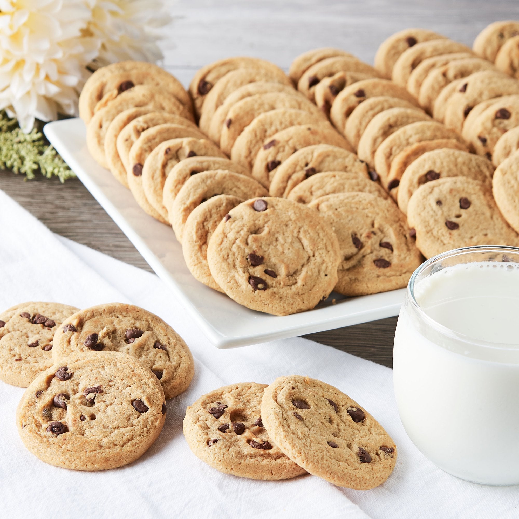 Little Dutch Boy chocolate chip cookies on a platter with a glass of milk